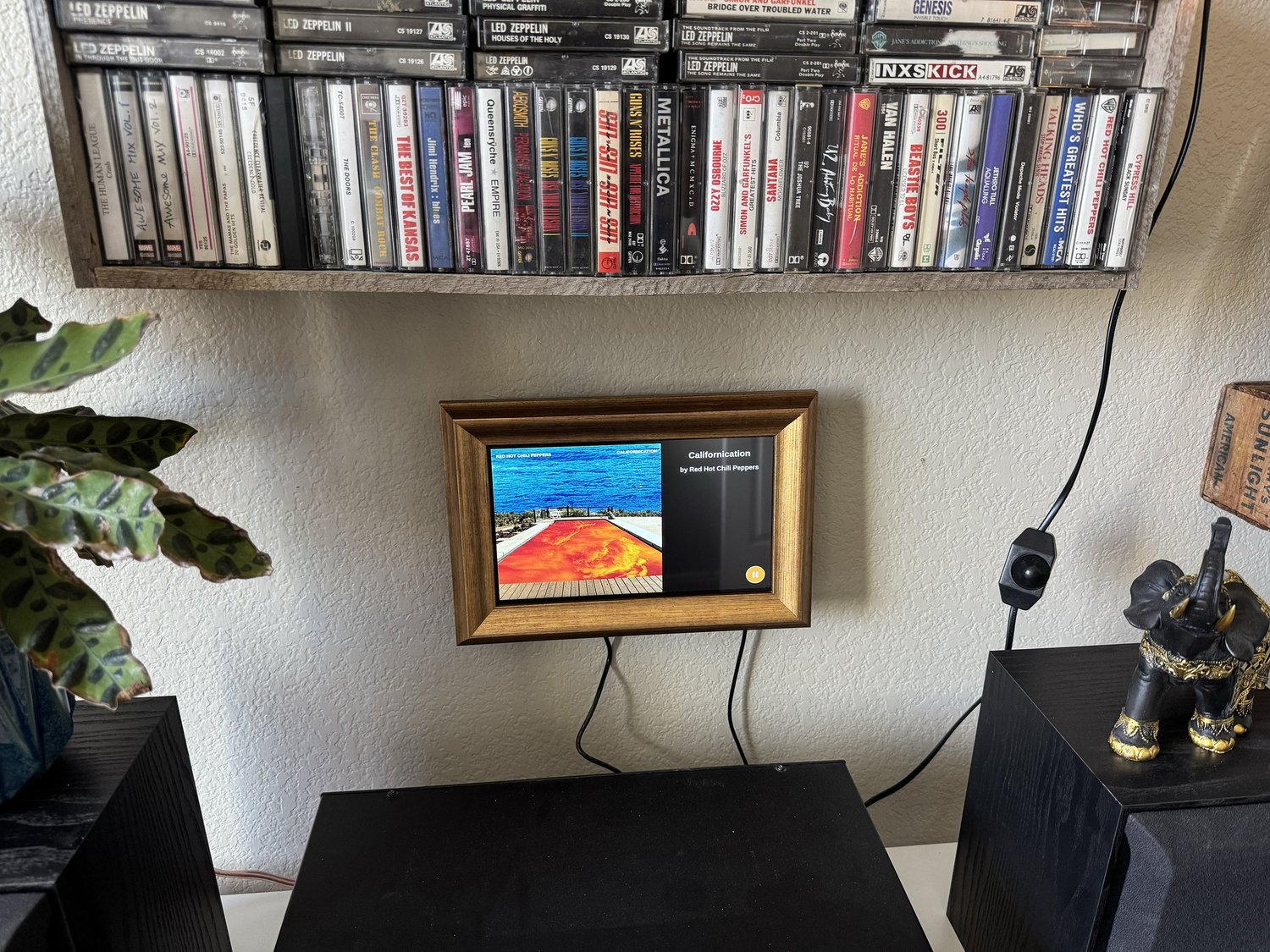 Framed Album Art Display installed below a wall-mounted cassette shelf