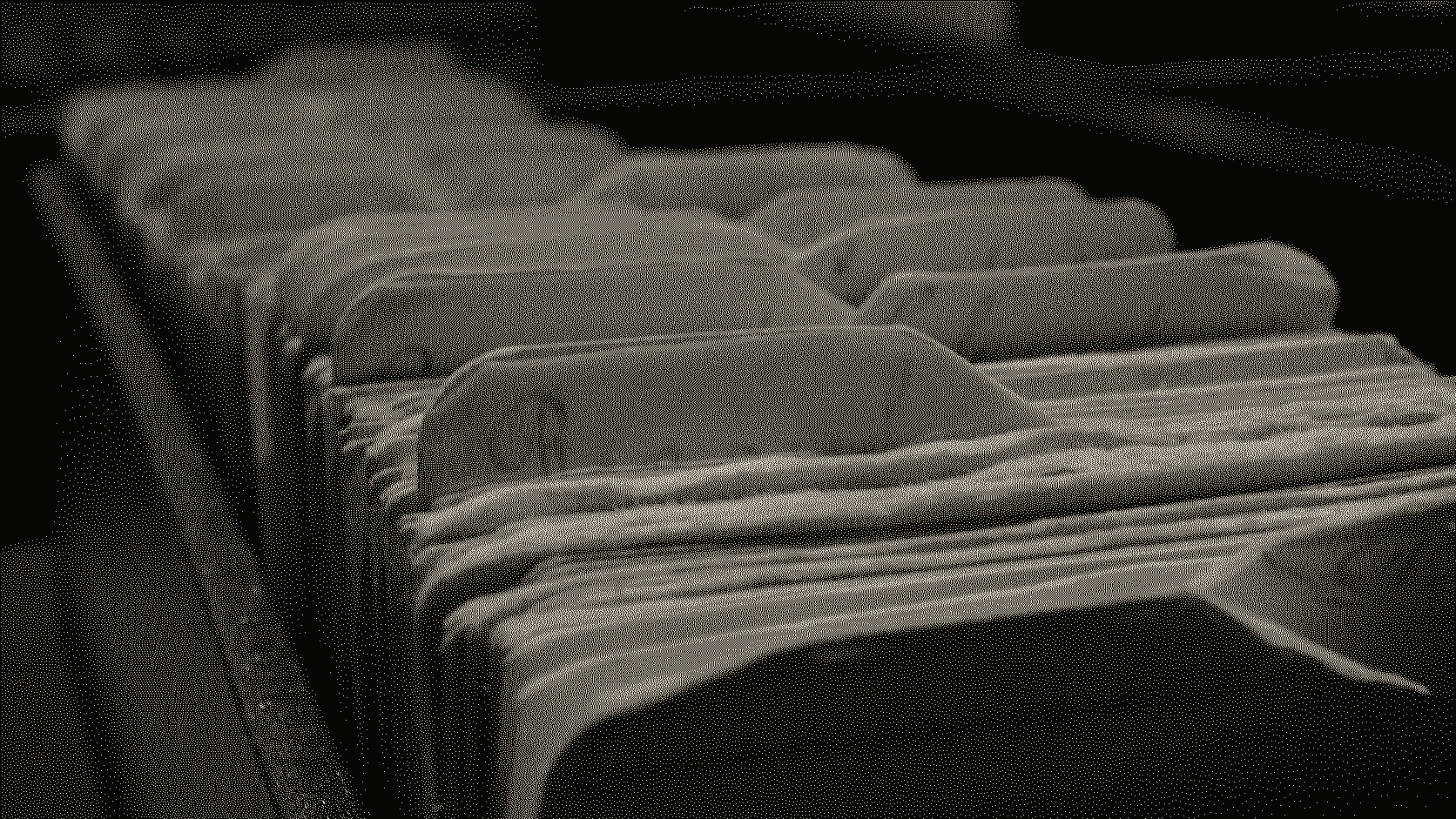 Rows of worn paper folders with handwritten index tabs receding into a dark archive drawer