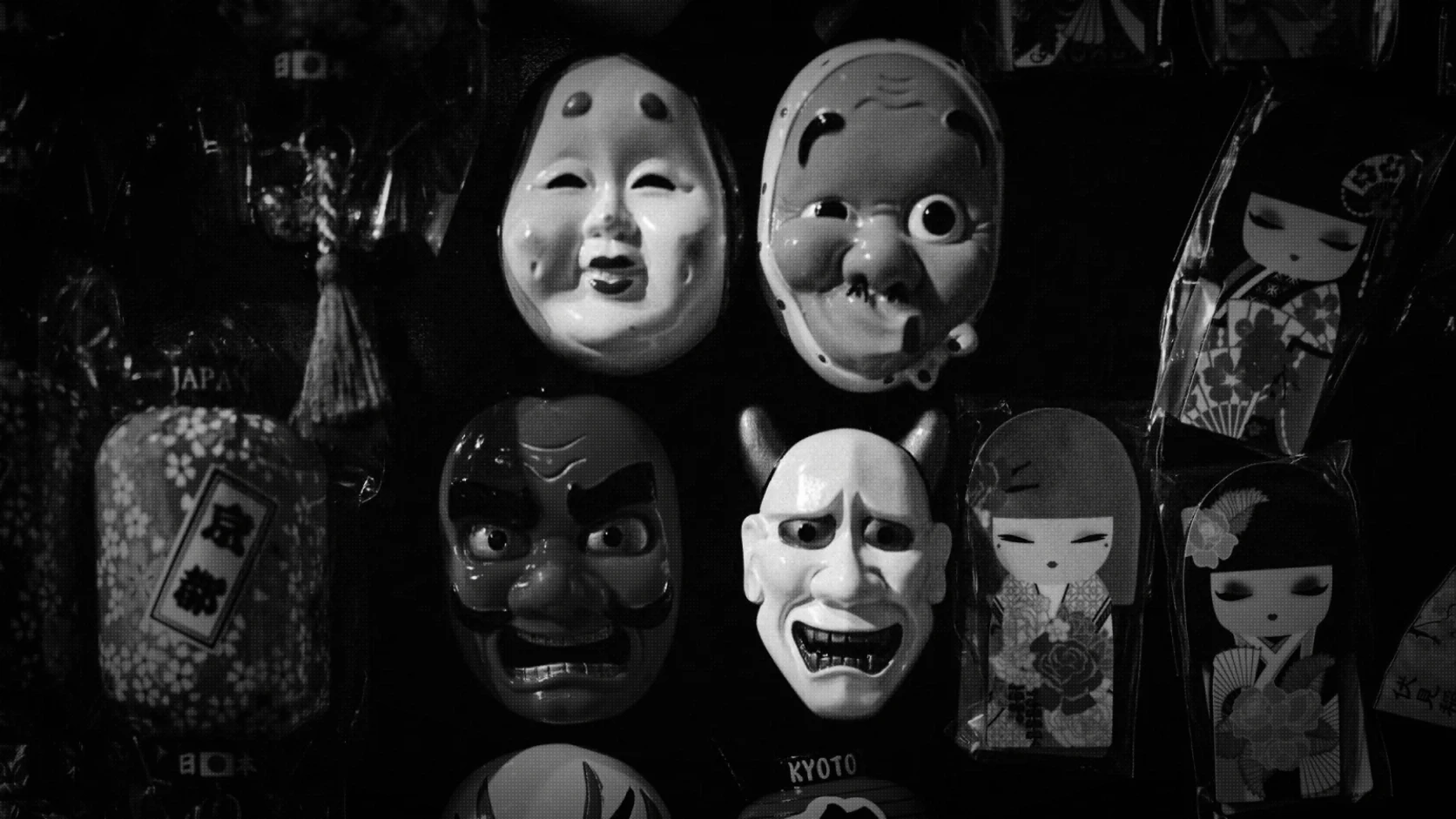 Traditional Japanese masks and souvenirs displayed together in a shop in Kyoto